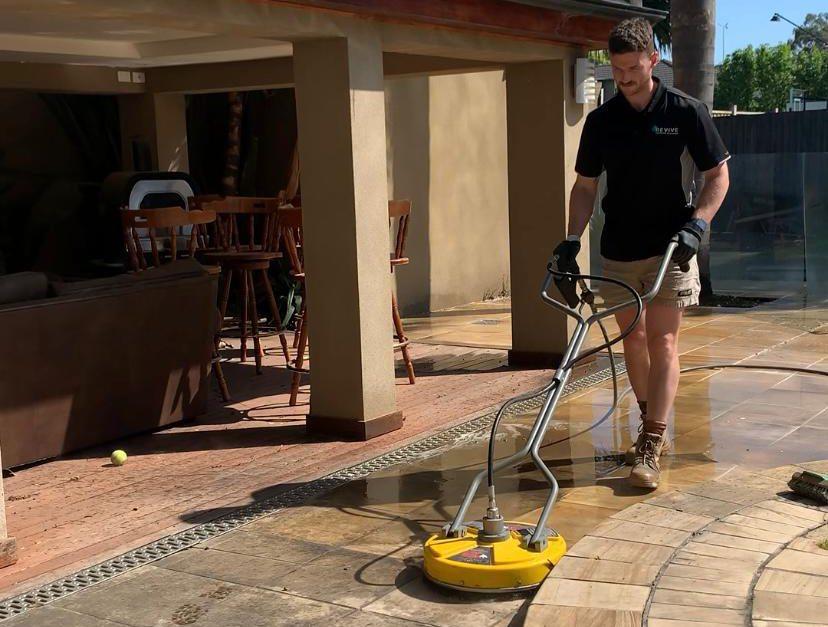 Draining excess water from the Karcher pressure washer hose after use.